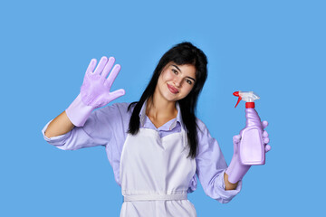 woman in gloves and cleaner apron with sponge and detergent sprayer