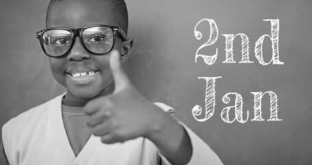 Composite of 2nd jan text and portrait of african american boy showing thumbs up, copy space