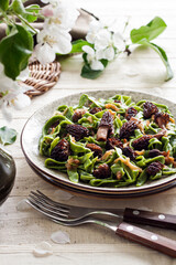 Homemade green nettle pasta with fried spring morel mushrooms
