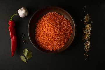 Lentils and spices on dark. Cooking lentil soup.