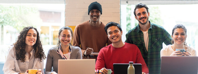 Horizontal banner or header with smiling multiethnic coworkers looking at camera making team...