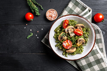 Mushroom and Spinach Pasta in a Bowl. vegan food concept. top view