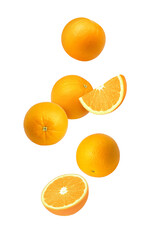 Orange fruit with cut half sliced and green leaf flying in the air isolated on white background.