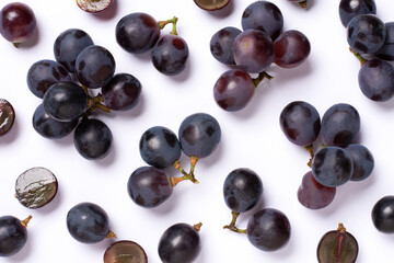 Bunch of black grape isolated on white background, top view, flat lay.