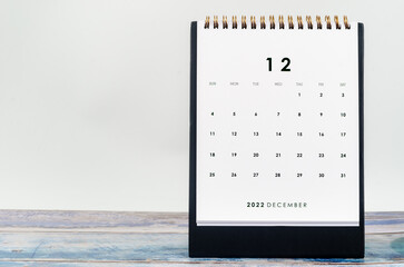 The December 2022 Monthly desk calendar for 2022 year on old blue wooden background