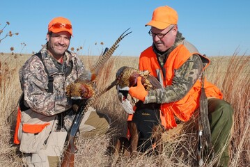 A pair of hunters and their take of pheasants 