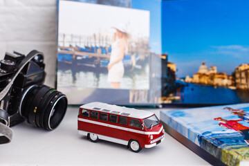 The concept of trip for a travel company. toy bus, plane and photo book, photo album