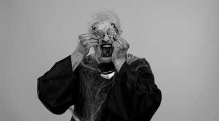 Spooky man with bloody scars face, Halloween zombie showing golden bitcoins. Achievement career...
