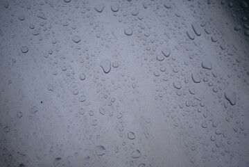 background of a light gray iron shiny sheet of iron, after the rain with dew drops, after the rain, the texture of water drops on a steel sheet with a shadow