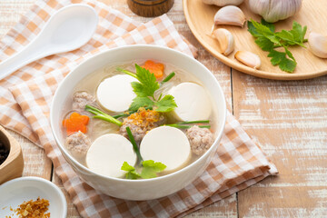 Clear soup with soy bean curd ,Minced Pork and Vegetables in white bowl