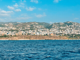 View of Famous and Historic Mediterranean Coastal Town: Byblos, Lebanon - Tourist attractions of Byblos with restaurants and boats in Lebanon - view from the ocean