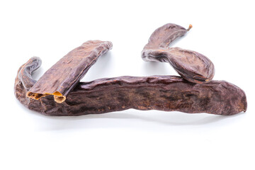 closeup of carob isolated on a white background