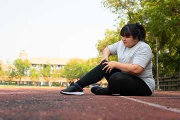 Fototapeta premium Asian overweight woman a new runner pain ankle during running, Athlete runner training accident. Sport running ankle sprained sprain cause injury. weight loss, workout, sports, health care concepts