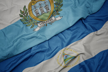 waving colorful flag of san marino and national flag of nicaragua. 3d illustration