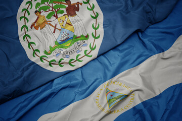 waving colorful flag of belize and national flag of nicaragua. 3d illustration