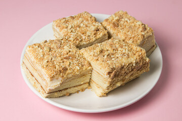 Cake slices on a pink background. Delicious homemade cake.