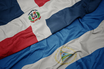 waving colorful flag of dominican republic and national flag of nicaragua. 3d illustration