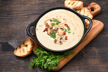 Mushroom soup with bread and fresh mushrooms, autumn seasonal cream soup with vegetables