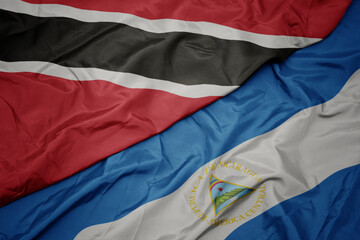 waving colorful flag of trinidad and tobago and national flag of nicaragua. 3d illustration