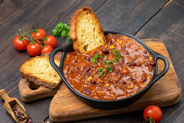 Bean and corn soup or ragout, red bean stew on a wooden background. Food Protein Vegan dish