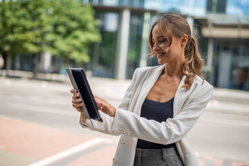 Businesswoman using a digital tablet outdoor