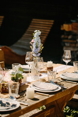 wedding decor ceremony dining tables with flowers tableware plates forks spoons knives napkins vases candles glasses gala dinner outdoor restaurant