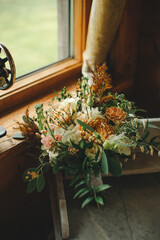 wedding beautiful bouquet with different flowers roses greenery indoors sewing machine decor