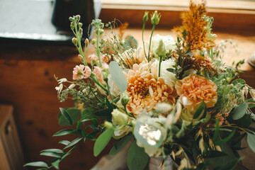 wedding beautiful bouquet with different flowers roses greenery indoors sewing machine decor