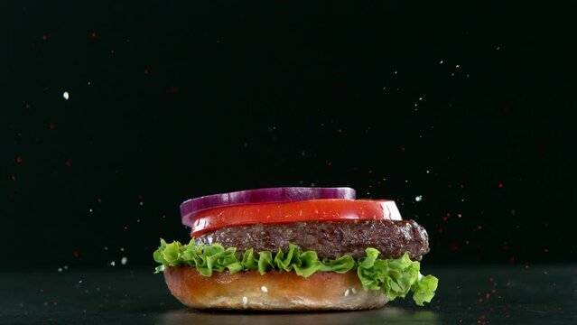 Super slow motion of stacking hamburger pieces with fire. Filmed on high speed cinema camera, 1000 fps.