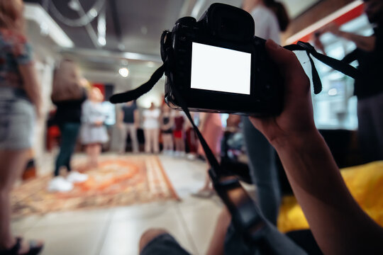 cameraman with a camera works in a business training class. close-up.