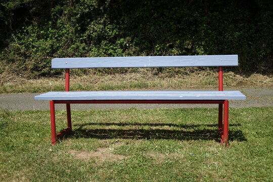 Blue and red wood and metal resting bench in Northern Palatinate (Pf&auml;lzer Bergland) landscape, sunny spring day, concept: rest, relaxation, outdoor (horizontal), Wolfstein, RLP, Germany