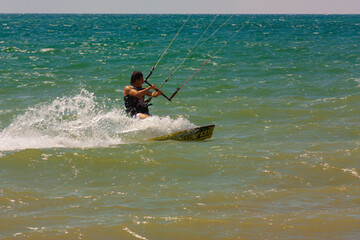 riding the kite in the sea on the waves