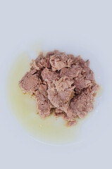 top view of tuna fish with oil on plate 