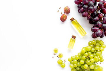 Grape seed oil in bottles with bunch of grapes. Eco cosmetic product