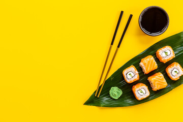 Salmon sushi rolls set on Bamboo leave, top view. Eco serving © 9dreamstudio