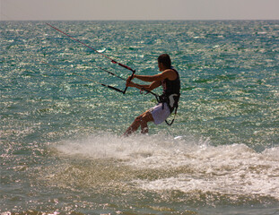 riding the kite in the sea on the waves