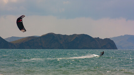 riding the kite in the sea on the waves