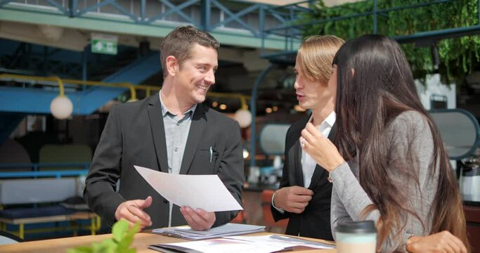 Group of business people reading contract document together, They consult with one another,�before doing business together.