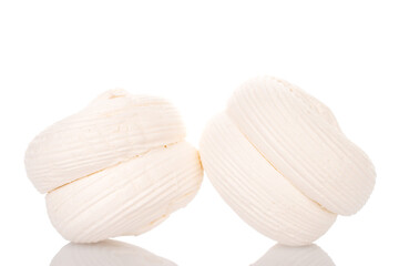 Two sweet white marshmallows, macro, isolated on white background.