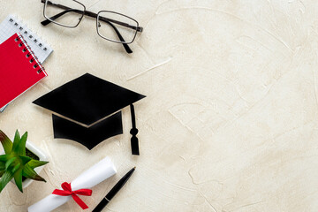 Academic cap or graduation hat on students desk. Education concept