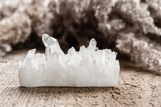Pure Quartz Crystal Cluster on Wooden Background