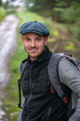 Happy hiker smiling. Footpath in the woods in Scotland. High quality photo