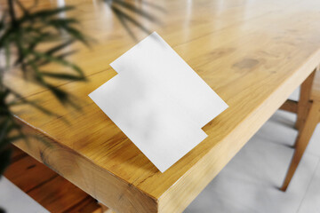 Clean minimal business card mockup on wooden table with plant