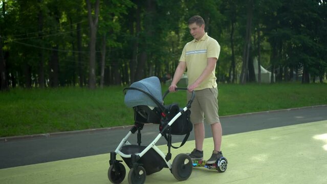 A young dad walks with his son in the park