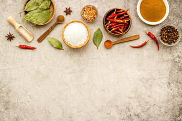 Colorful cooking background with spices and herbs in bowls, top view