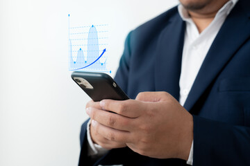 Businessman using mobile phone to check work performance report showing in bar graph pop-up screen