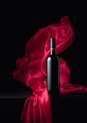 Вottle of red wine with flutters red cloth.