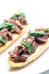 roasted livers on toasted baguette with sage leaves
