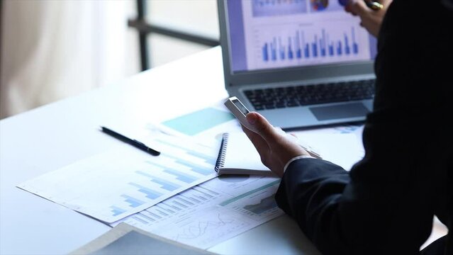 Company finance staff preparing financial documents, company finance staff preparing company finance documents to bring to the meeting to summarize for management's acknowledgment. Financial concept.