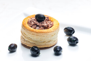 puff pastry filled with terrine served with black olives